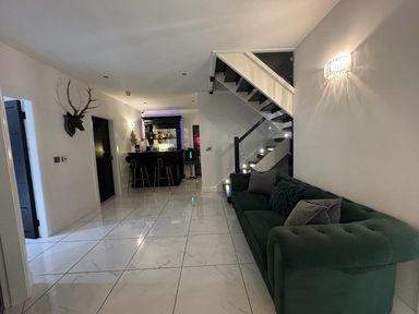 A hallway with a sofa and staircase at Jeannies retreat at little lake fb