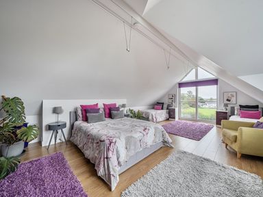 A bedroom with beds and a window at 5 Bed House, Sleeps 14 with Hot Tub and Bar, Tavistock