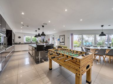 A kitchen with a foosball table and dining area at 5 Bed House, Sleeps 14 with Hot Tub and Bar Tavistock