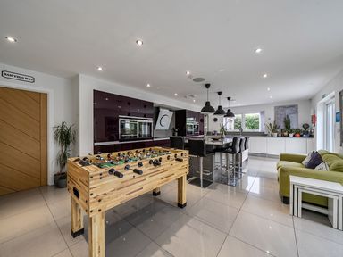 A kitchen with a foosball table and island seating at 5 Bed House, Sleeps 14 with Hot Tub and Bar Tavistock