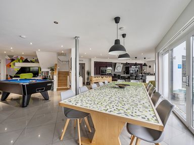 An indoor dining room with a pool table and a large dining table at 5 Bed House, Sleeps 14 with Hot Tub and Bar, Tavistock