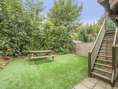 A garden with a table and staircase at 2 Bed, Sleeps 4 with Parking and EV charging, Wadebridge