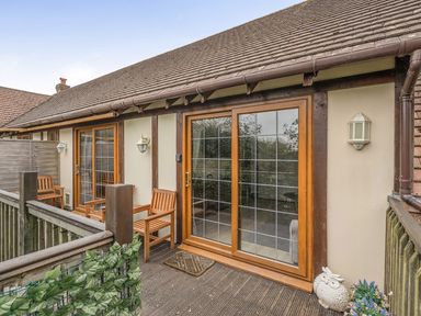 An outdoor area with wooden deck and chairs at 2 Bed, Sleeps 4 with Parking and EV charging, Wadebridge