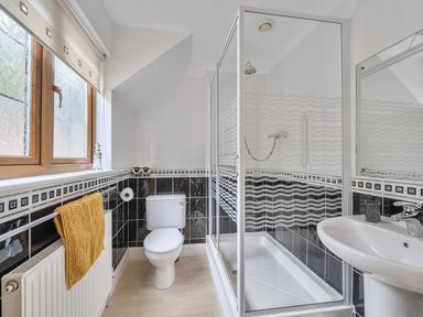 A bathroom with shower, toilet, and sink at 2 Bed, Sleeps 4 with Parking and EV charging in Wadebridge
