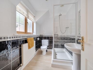 A bathroom with a shower and toilet at 2 Bed, Sleeps 4 with Parking and EV charging in Wadebridge
