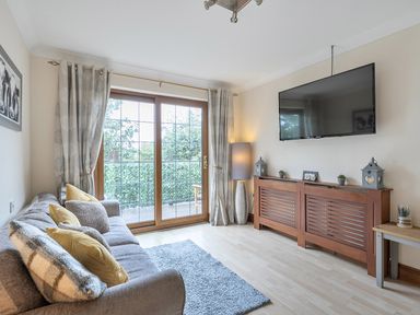 A living room with a sofa and television at 2 Bed, Sleeps 4 with Parking and EV charging in Wadebridge