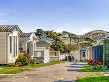 A row of caravans in an outdoor area at 2 Bed Caravan, Sleeps 4 with Sea Views, West Lulworth