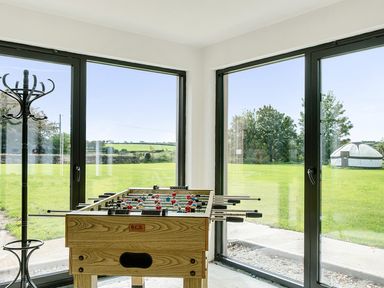 A game room with a football table and coat rack at Yurt, Sleeps 2 with BBQ and Fire Pit Tregooden Farm near St Tudy