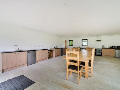 A kitchen with a dining table and chairs at Yurt, Sleeps 2 with BBQ and Fire Pit, Tregooden Farm near St Tudy