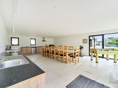 A kitchen with a large table and chairs at Yurt, Sleeps 2 with BBQ and Fire Pit Tregooden Farm near St Tudy