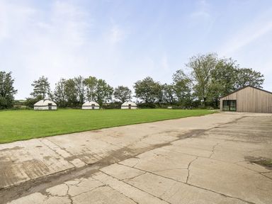 An outdoor area with yurts and a building at Yurt, Sleeps 5 and Dogs Welcome