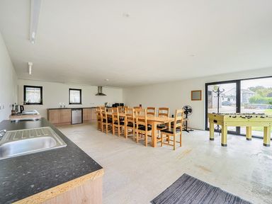 A kitchen with dining table and foosball table at Yurt, Sleeps 5 and Dogs Welcome