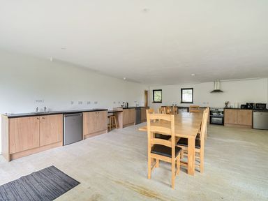 A kitchen with wooden cabinets and table at Yurt, Sleeps 5 and Dogs Welcome