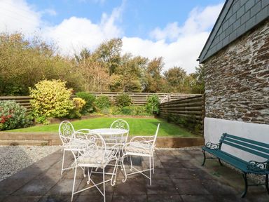 A garden with a table and chairs at The Old Dairy in 