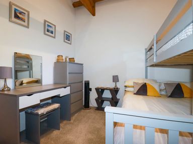 A bedroom with a bunk bed and dressing table at The Old Dairy in 