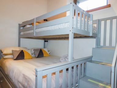 A bedroom with a bunk bed and a double bed at The Old Dairy in 