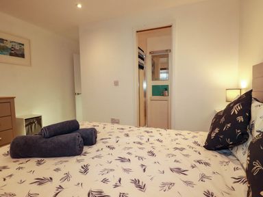 A bedroom with a bed and towels on it at The Old Dairy in Wadebridge
