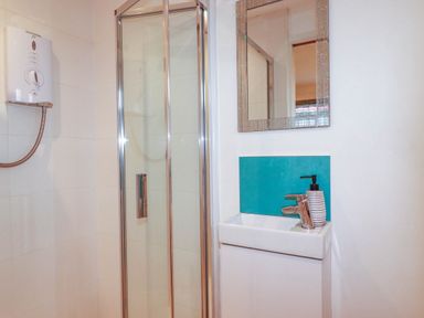 A bathroom with a shower and sink at The Old Dairy in Wadebridge