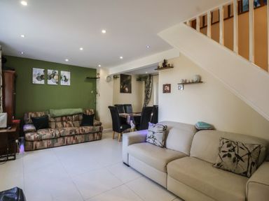 A living room with sofas and a dining area at 19 Hailey Road