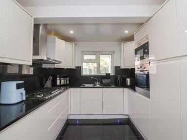 A kitchen with cabinets, sink, stove, and oven at 19 Hailey Road