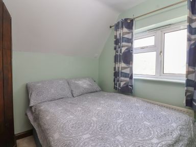 A bedroom with a bed and window at 19 Hailey Road