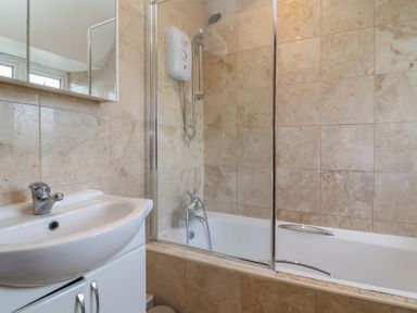 A bathroom with a sink and bathtub at 19 Hailey Road