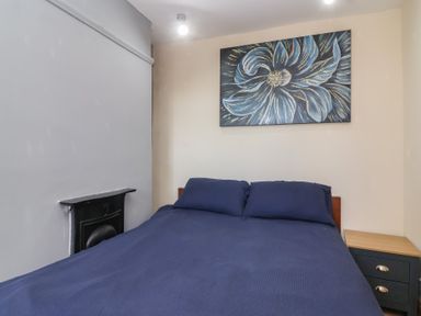 A bedroom with a bed and nightstand at 19 Hailey Road