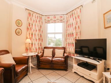 A living room with a sofa and television at Craig Y Glyn 