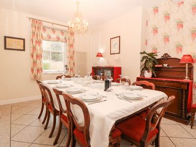 A dining room with a table set for dinner at Craig Y Glyn