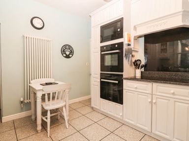 A kitchen featuring a table and chairs at Craig Y Glyn