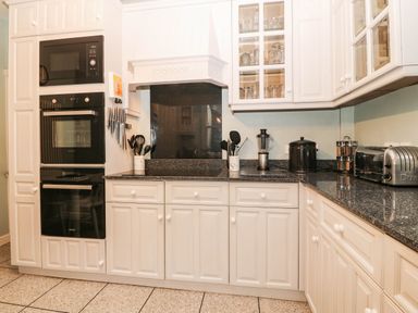 A kitchen with appliances and storage at Craig Y Glyn 