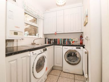 A laundry room with washing machine and tumble dryer at Craig Y Glyn