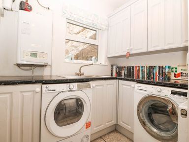 A laundry room with a washing machine and dryer at Craig Y Glyn