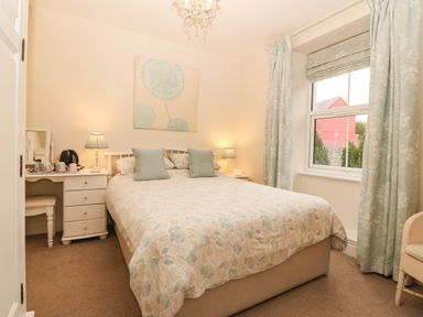 A bedroom with a bed and desk at Craig Y Glyn 