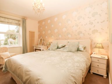 A bedroom with a bed and bedside table at Craig Y Glyn