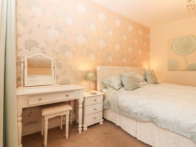 A bedroom with a bed and dresser at Craig Y Glyn 