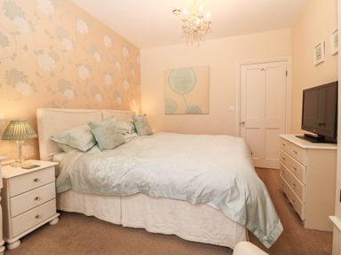 A bedroom with a bed and television at Craig Y Glyn