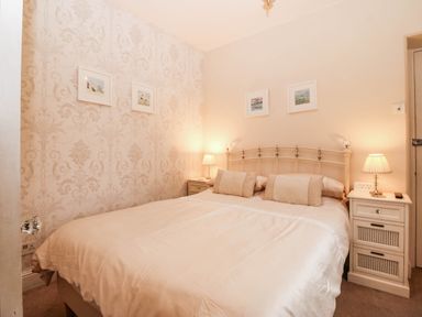 A bedroom with a bed and nightstands at Craig Y Glyn
