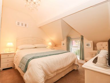 A bedroom with a bed and window at Craig Y Glyn