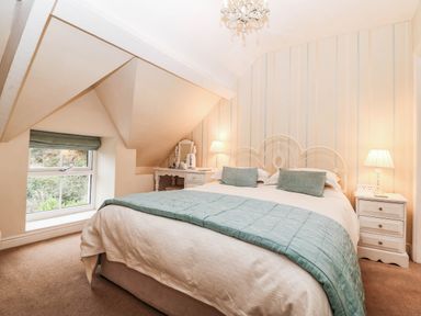 A bedroom with a bed and bedside tables at Craig Y Glyn