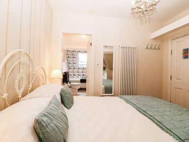 A bedroom with a bed and a bathroom visible at Craig Y Glyn