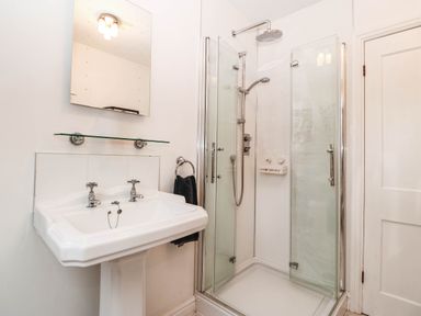 A bathroom with a sink and enclosed shower at Craig Y Glyn
