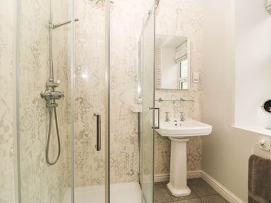 A bathroom with a shower and sink at Craig Y Glyn