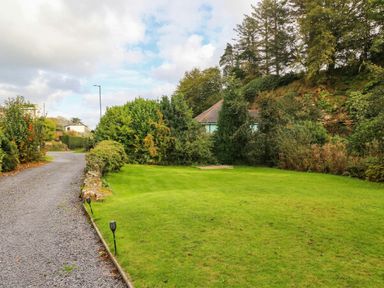 A garden area with a path and greenery at Craig Y Glyn