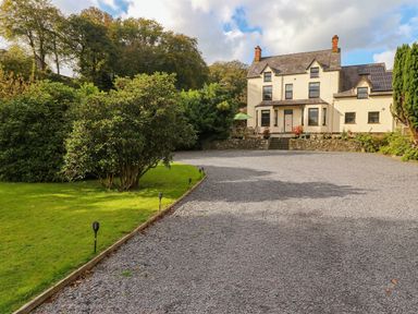 A house with garden and gravel pathway at Craig Y Glyn