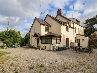A house with gravel outdoor area and garden furniture at Craig Y Glyn Cottage Pwllheli