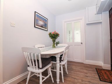 A dining room with a table and chairs at Craig Y Glyn Cottage Pwllheli