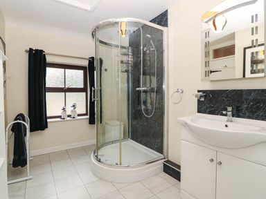 A bathroom with a shower and sink at Craig Y Glyn Cottage Pwllheli