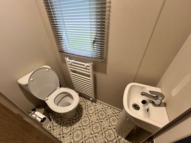 A bathroom with a toilet and sink at Hafan y Mor - 159 Snowdonia Pwllheli