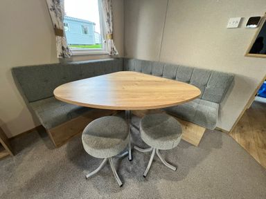 A dining area with a table and seating at Hafan y Mor - 159 Snowdonia Pwllheli